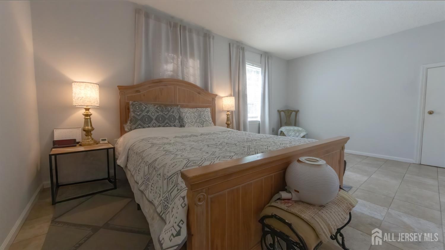320 Sharon Way, Unit B Monroe Township, NJ 08831 - Photo 34 of 35 a bedroom with a bed and a mirror
