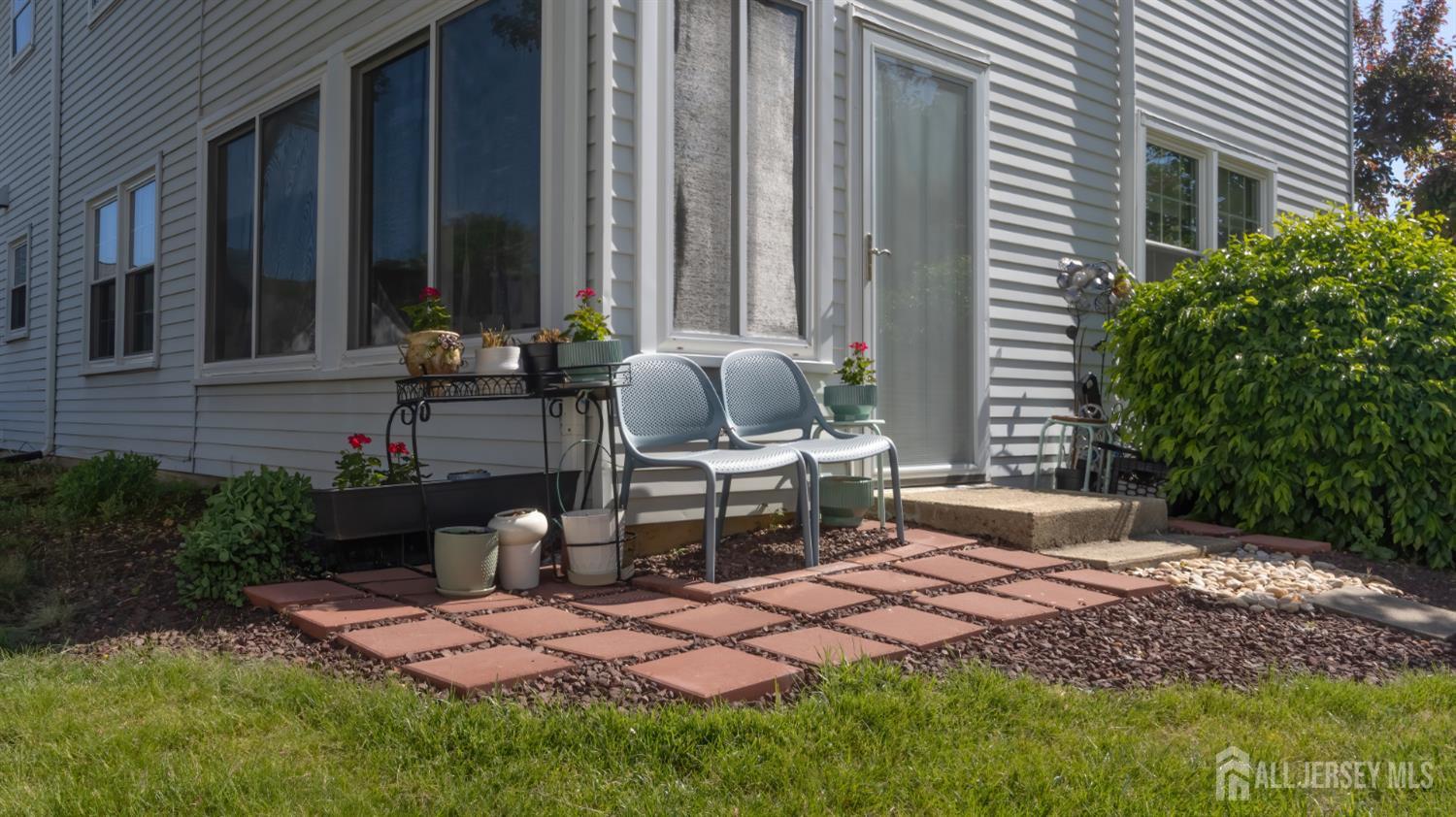320 Sharon Way, Unit B Monroe Township, NJ 08831 - Photo 4 of 35 a view of a backyard with plants and outdoor seating