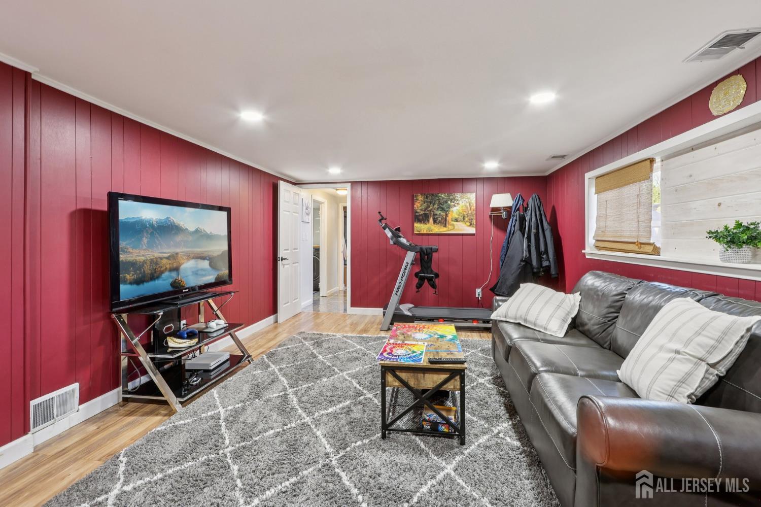 37 Merker Drive Edison, NJ 08837 - Photo 17 of 31 a living room with furniture a flat screen tv and a table