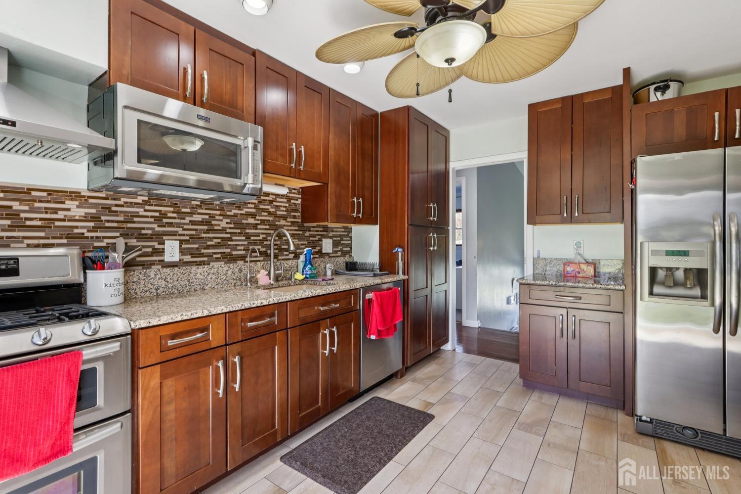 37 Merker Drive Edison, NJ 08837 - Photo 10 of 31 a kitchen with stainless steel appliances granite countertop a stove refrigerator and cabinets