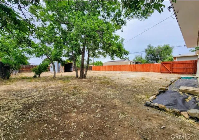 a view of backyard with large trees