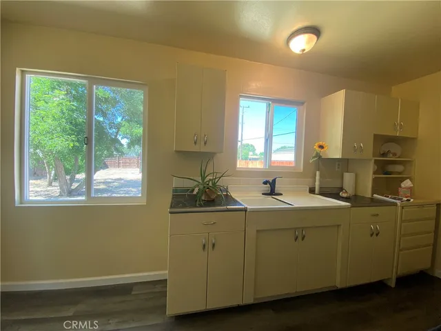 a kitchen with a sink and windows