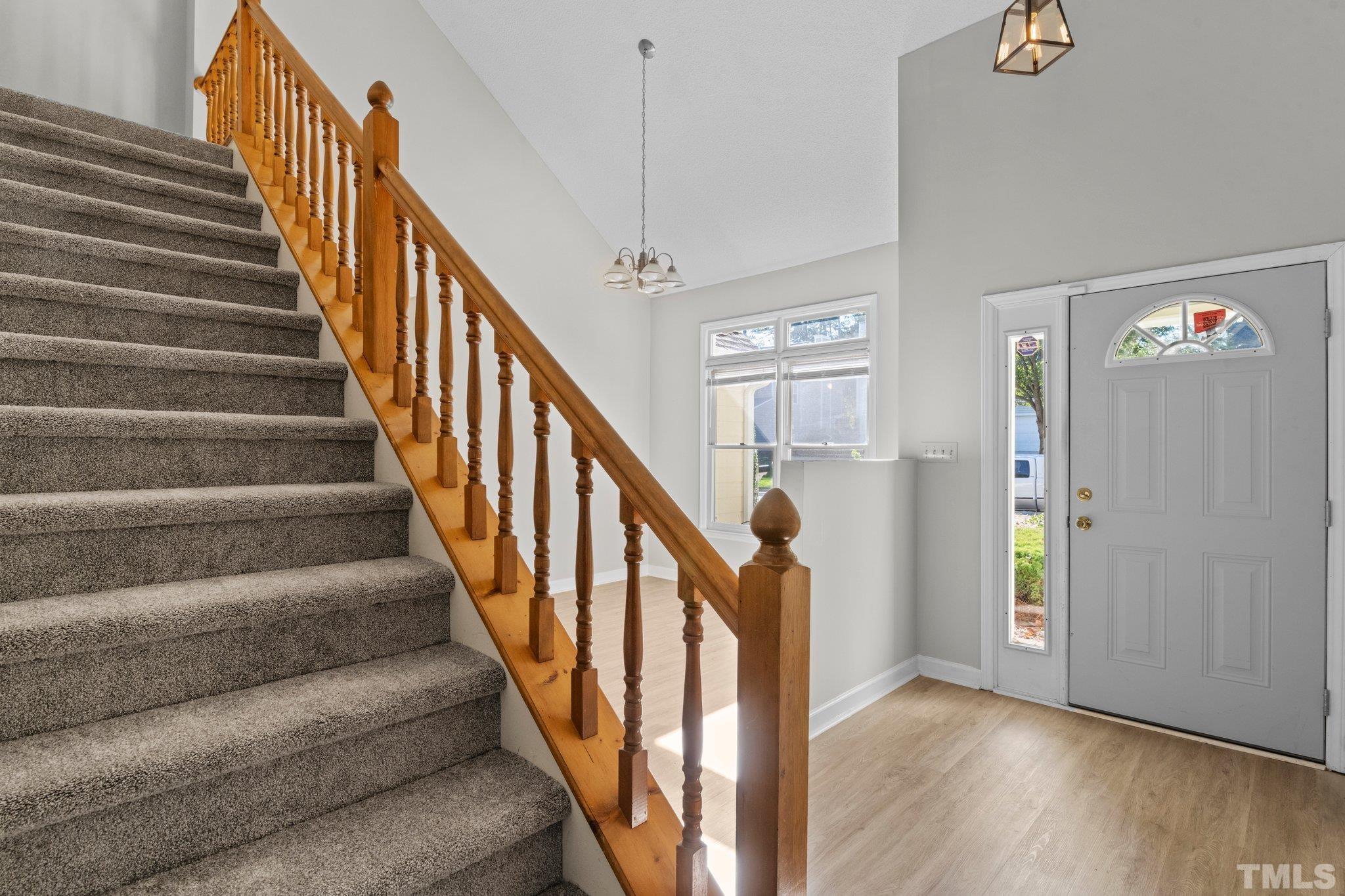 4405 Birmingham Way Raleigh, NC 27604 - Photo 12 of 22 a view of staircase with lots of frames on wall and wooden floor