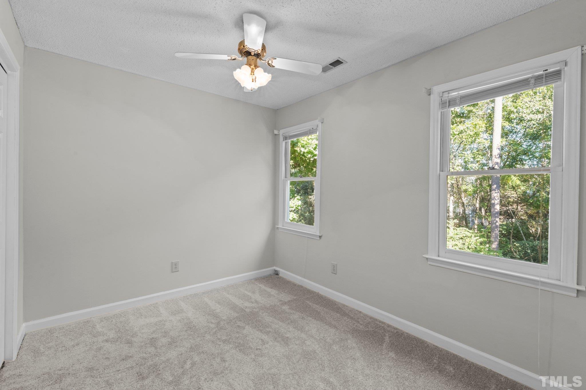 4405 Birmingham Way Raleigh, NC 27604 - Photo 13 of 22 an empty room with windows and fan