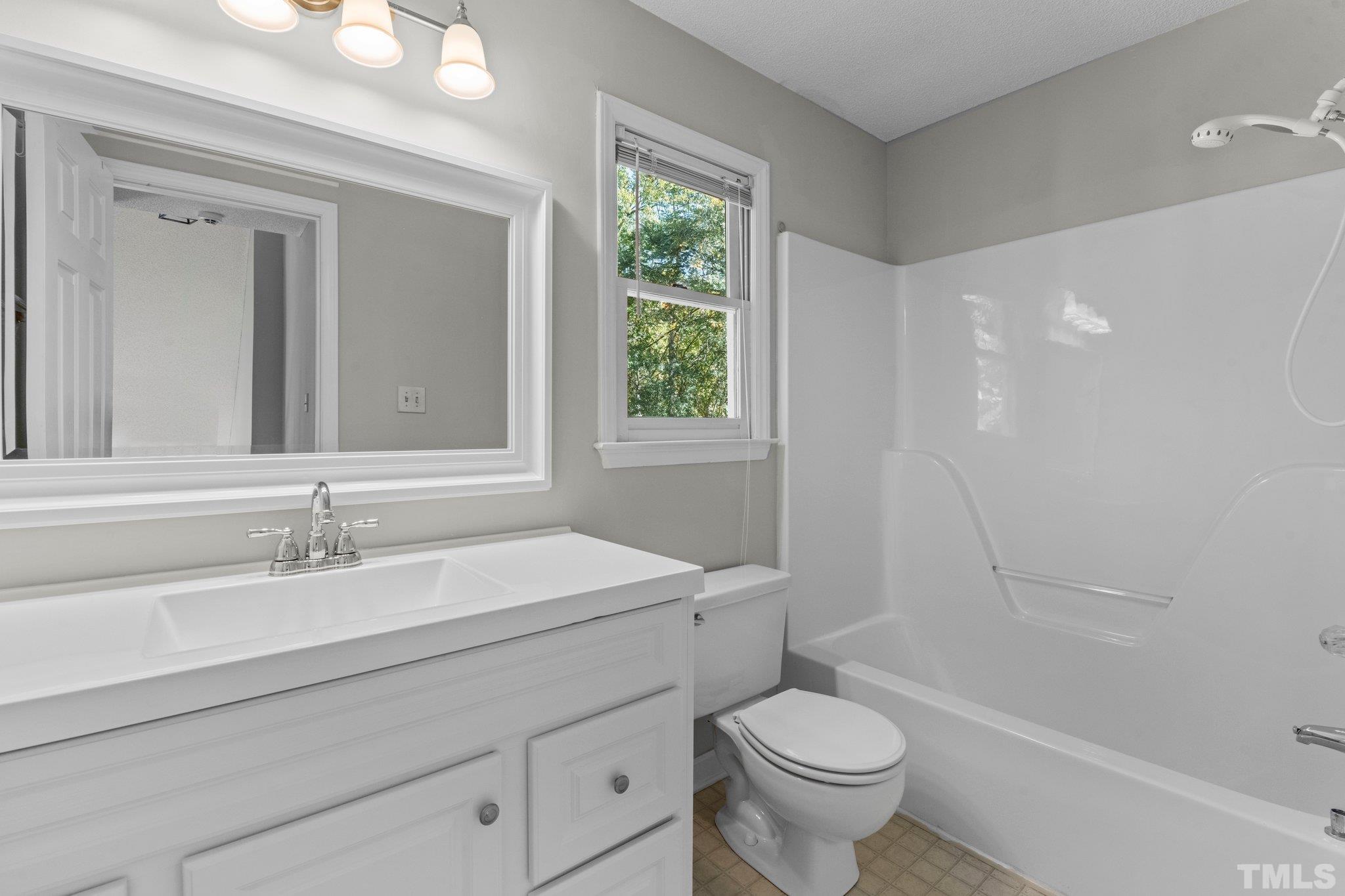 4405 Birmingham Way Raleigh, NC 27604 - Photo 14 of 22 a bathroom with a sink toilet and shower