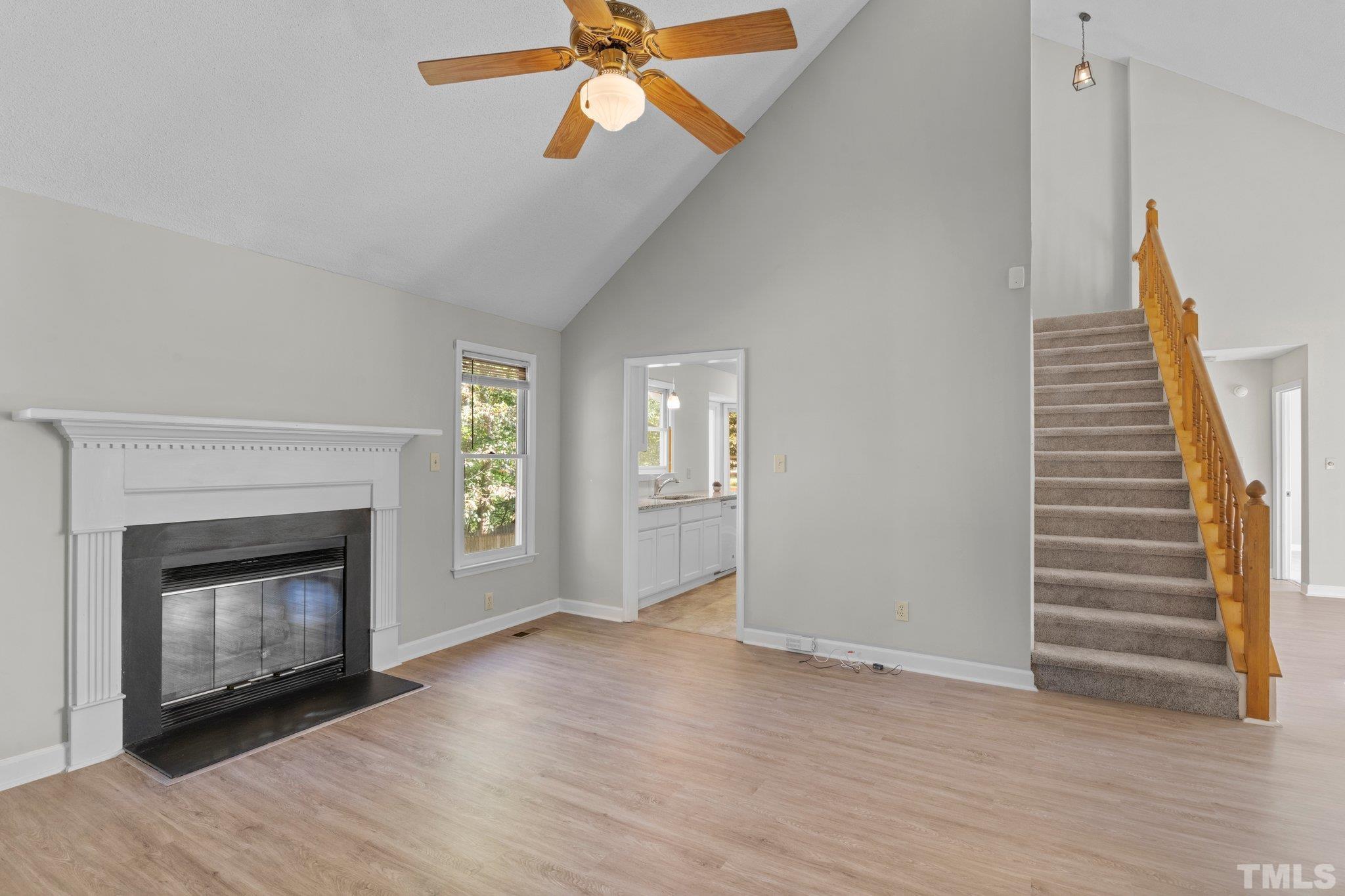 4405 Birmingham Way Raleigh, NC 27604 - Photo 9 of 22 a view of an empty room with wooden floor fireplace and a window