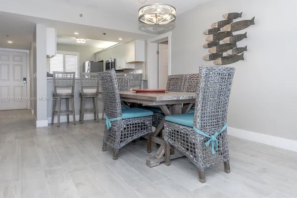 a dining room with furniture and a chandelier