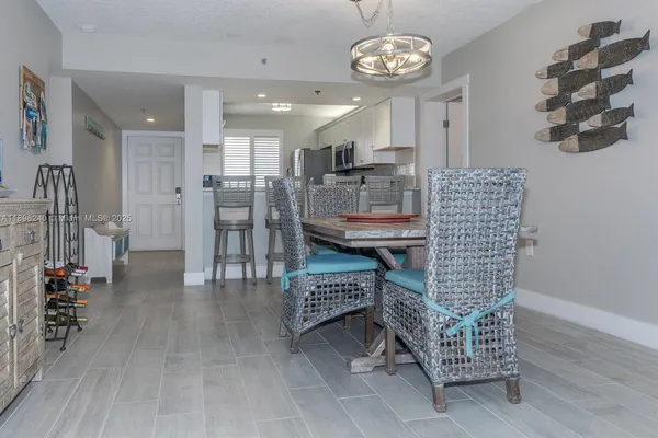a view of a dining room with furniture and a chandelier