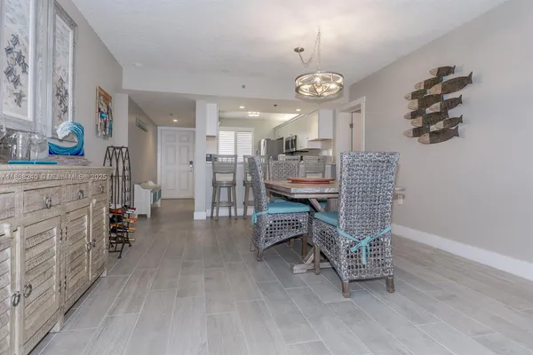 a view of a dining room with furniture and chandelier
