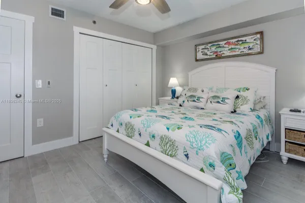 a view of a garden with a lot of flower plants and wooden fence