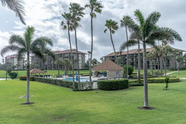 a view of a swimming pool with a lawn chairs