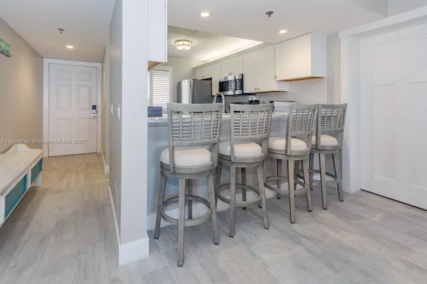 a large kitchen with a table and chairs