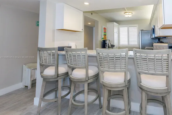a dining room with furniture and a wooden floor