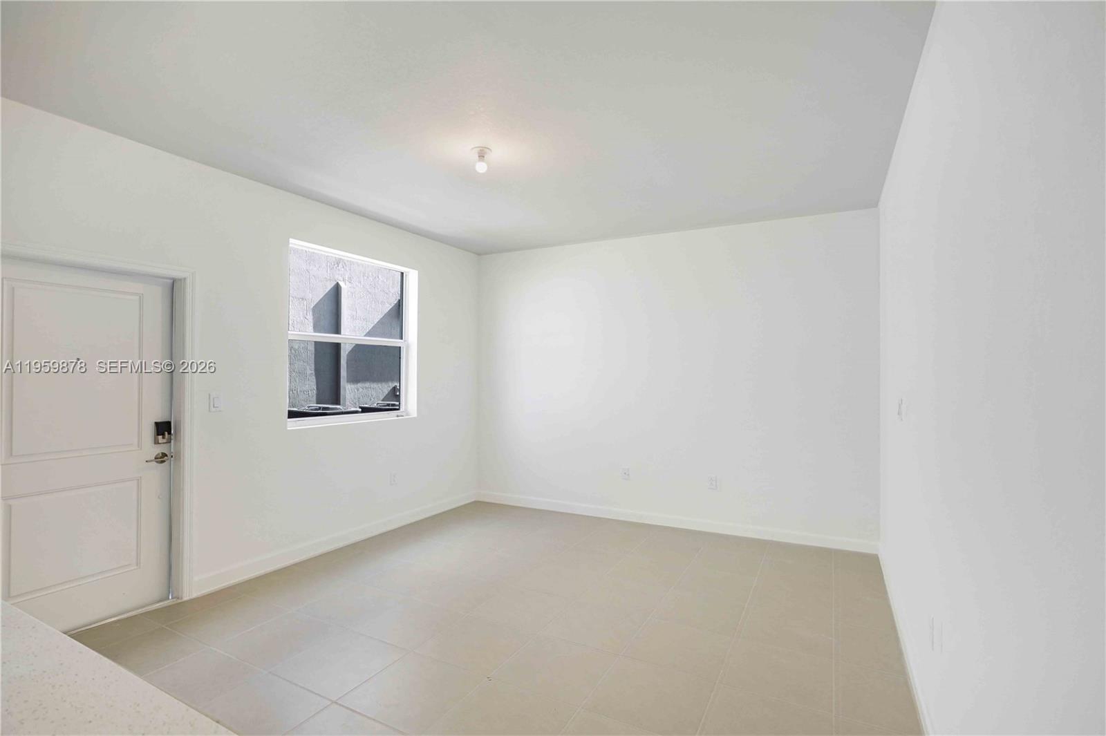 13621 Southwest 185th Lane, Unit A Miami, FL 33177 - Photo 8 of 9 an empty room with windows
