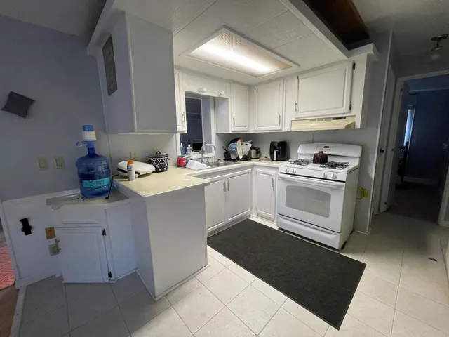 a kitchen with a sink stove and cabinets