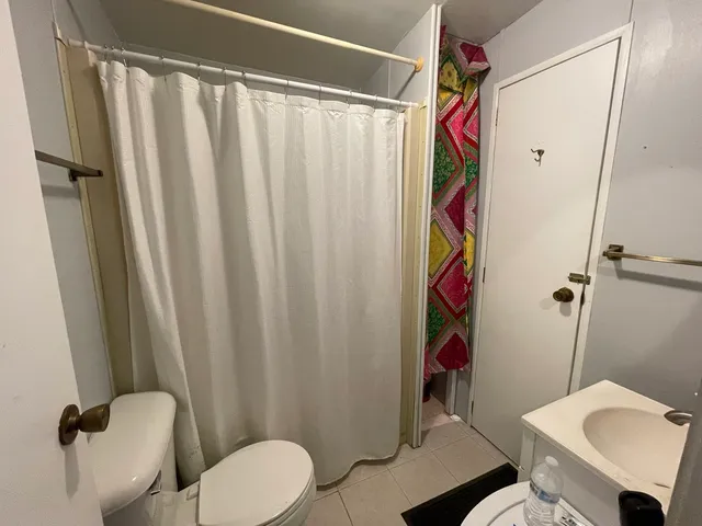 a bathroom with a shower curtain and a sink