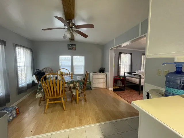 a view of a dining room with furniture and a chandelier