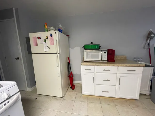 a white refrigerator freezer sitting in a kitchen