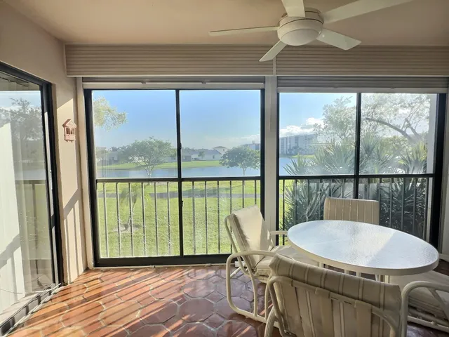 a balcony with table and chairs