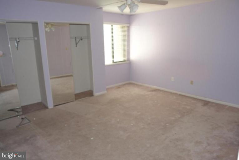 2109 Walsh View Terrace, Unit 301 Silver Spring, MD 20902 - Photo 2 of 4 an empty room with windows and closet