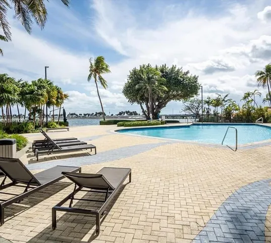 a view of a swimming pool with lounge chair