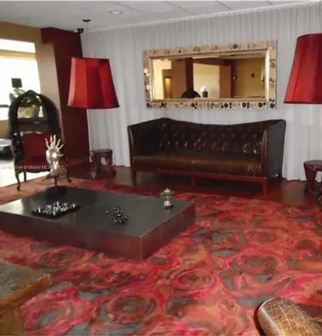 a living room with furniture a rug and a fireplace