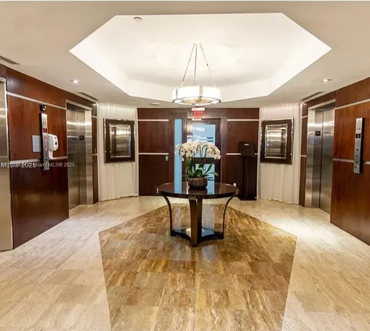 a view of a living room and chandelier