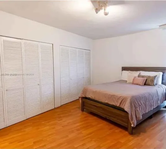 a bedroom with a bed and cabinet