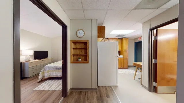 a bedroom with a bed and a mirror