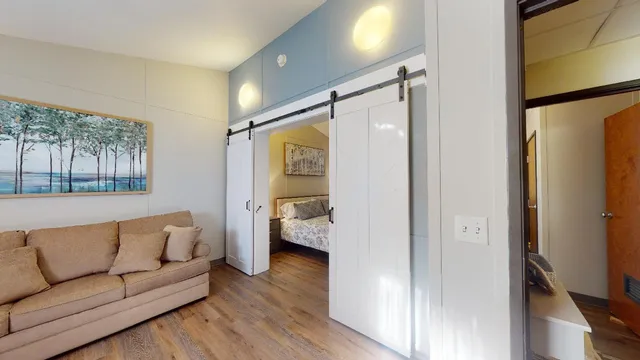 a living room with furniture and a walk in closet