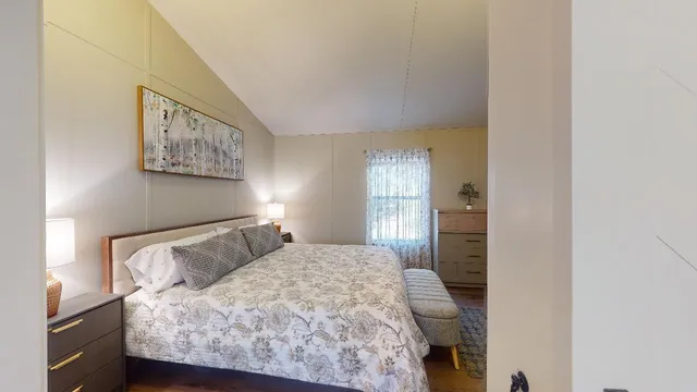 a bedroom with a large bed and a window