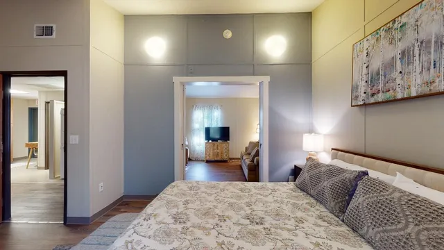 a bedroom with a bed and lamp