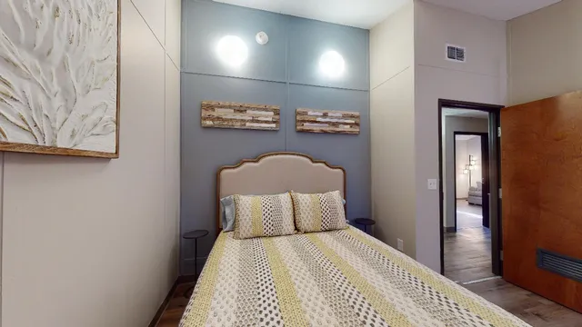 a bedroom with a bed and a night stand