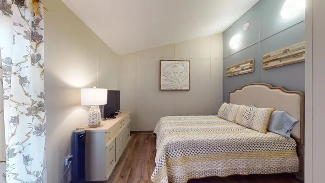 a bedroom with a bed and a lamp