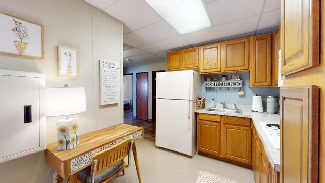 a kitchen with stainless steel appliances a refrigerator a sink and a cabinets