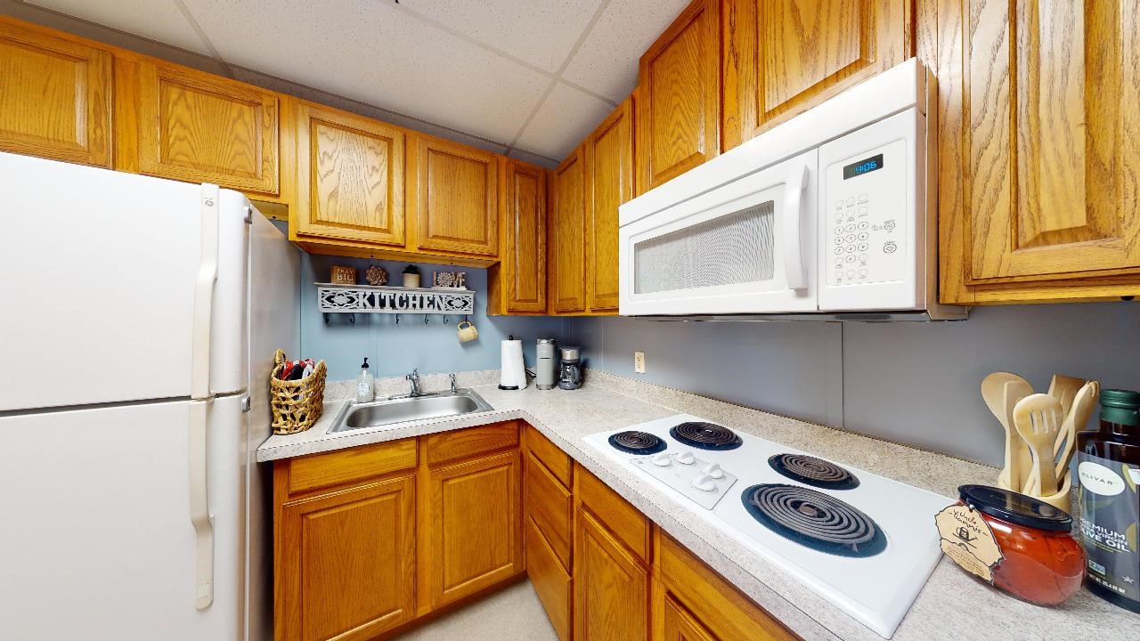 5585 Straub Road College Station, TX 77845 - Photo 6 of 50 a kitchen with a sink a stove and a refrigerator
