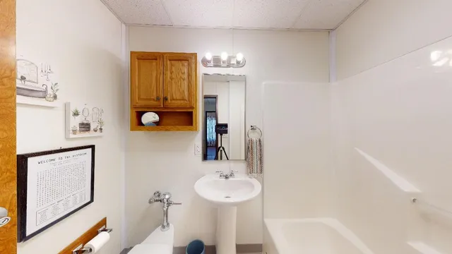 a bathroom with a sink and a mirror