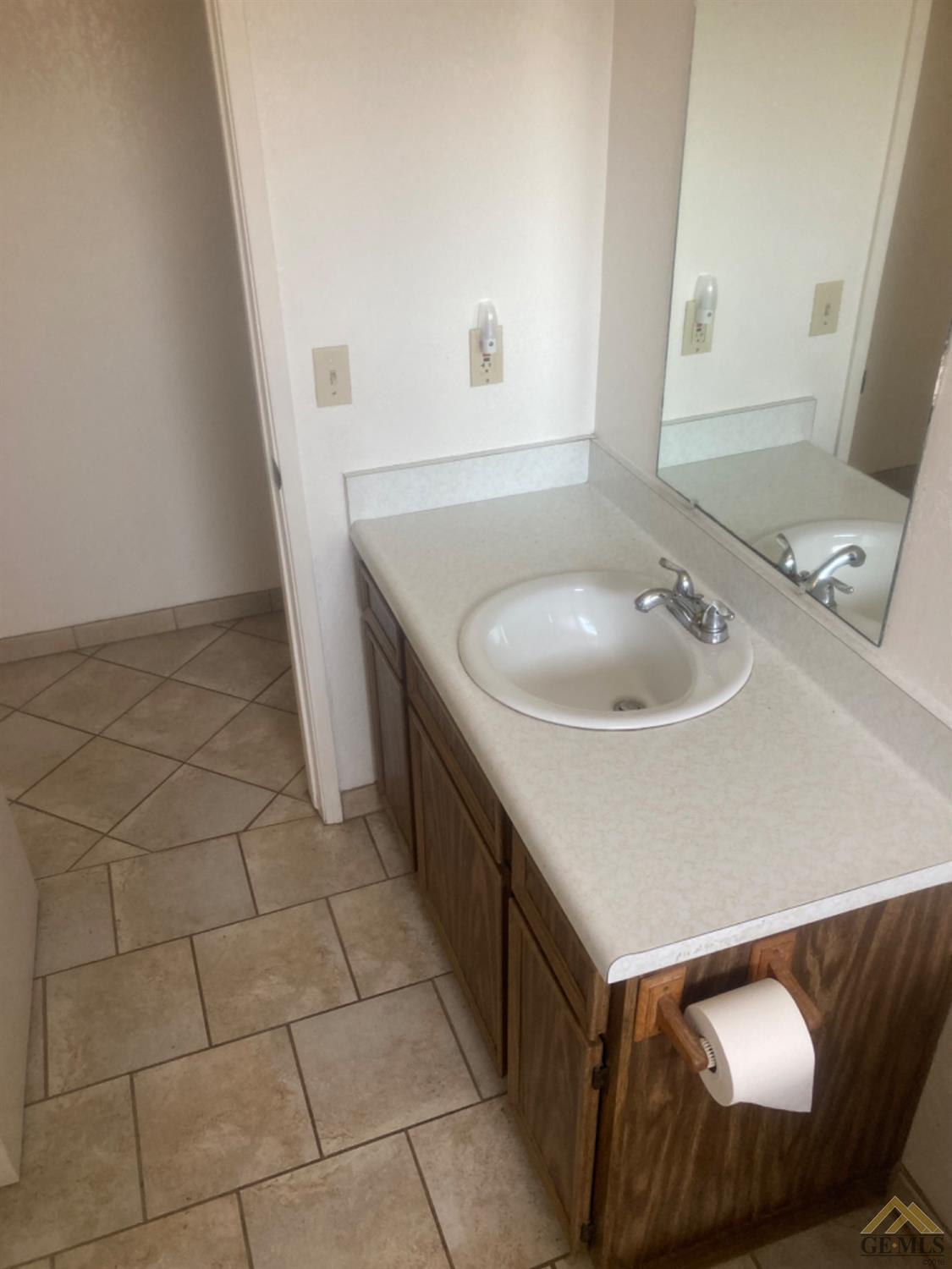 Undisclosed Address Buttonwillow, CA 93206 - Photo 23 of 56 a bathroom with a sink and a mirror
