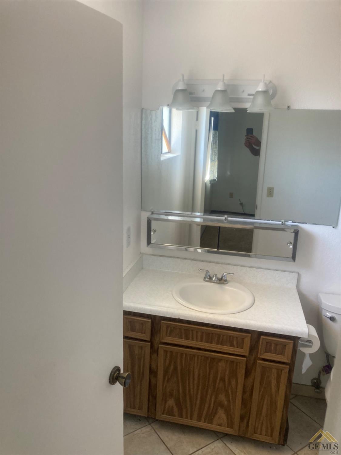 Undisclosed Address Buttonwillow, CA 93206 - Photo 31 of 56 a bathroom with a sink and a mirror