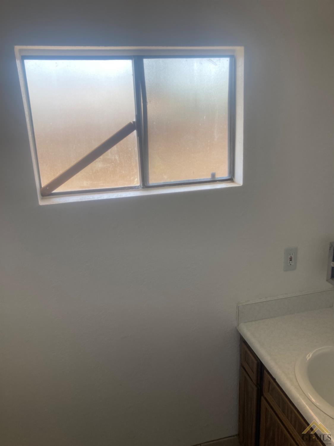 Undisclosed Address Buttonwillow, CA 93206 - Photo 34 of 56 a bathroom with a window sink and mirror