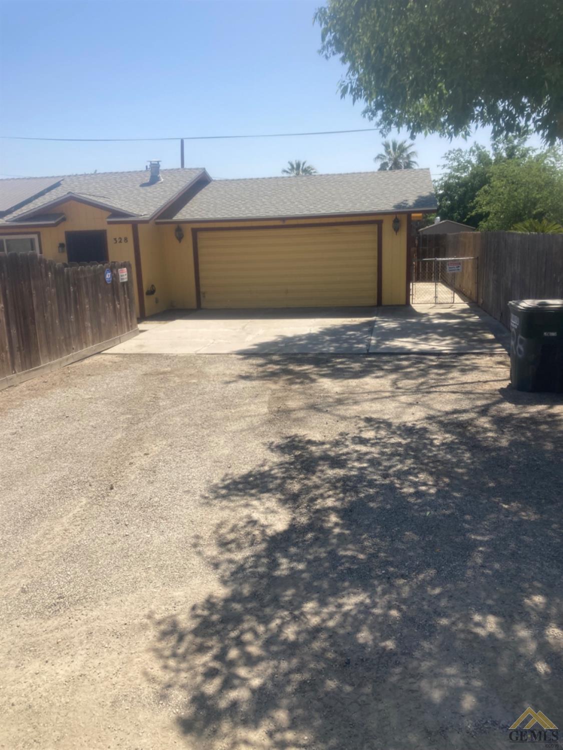 Undisclosed Address Buttonwillow, CA 93206 - Photo 4 of 56 a front view of a house with a yard