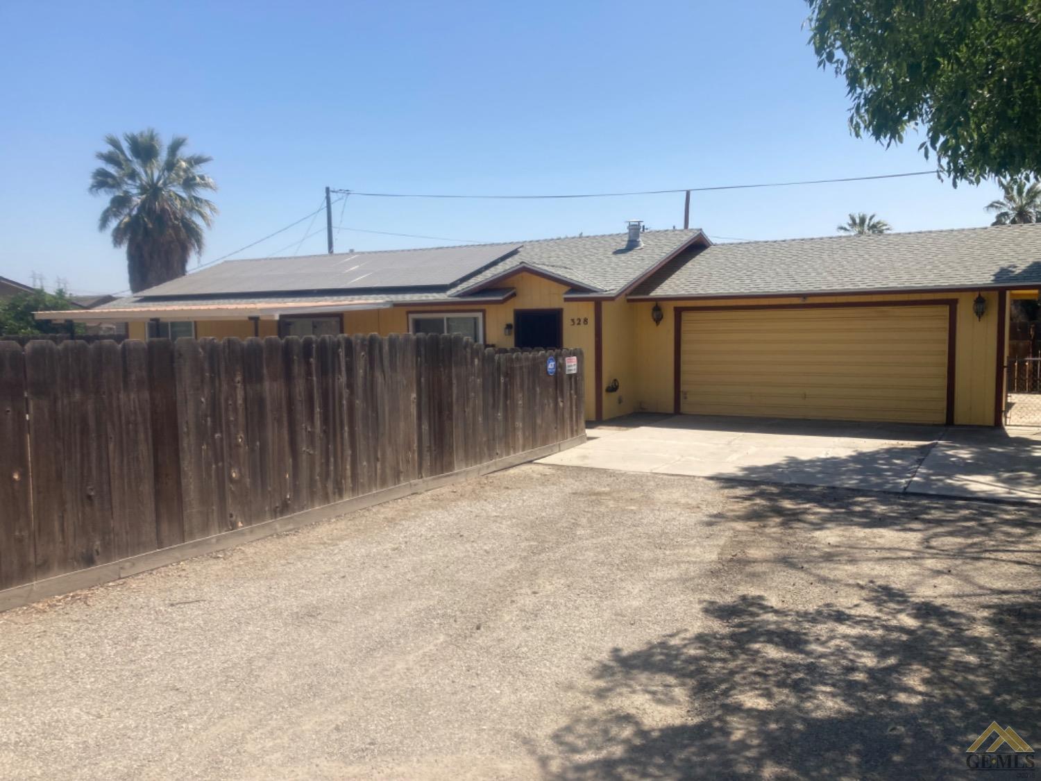 Undisclosed Address Buttonwillow, CA 93206 - Photo 5 of 56 a front view of a house with a garage