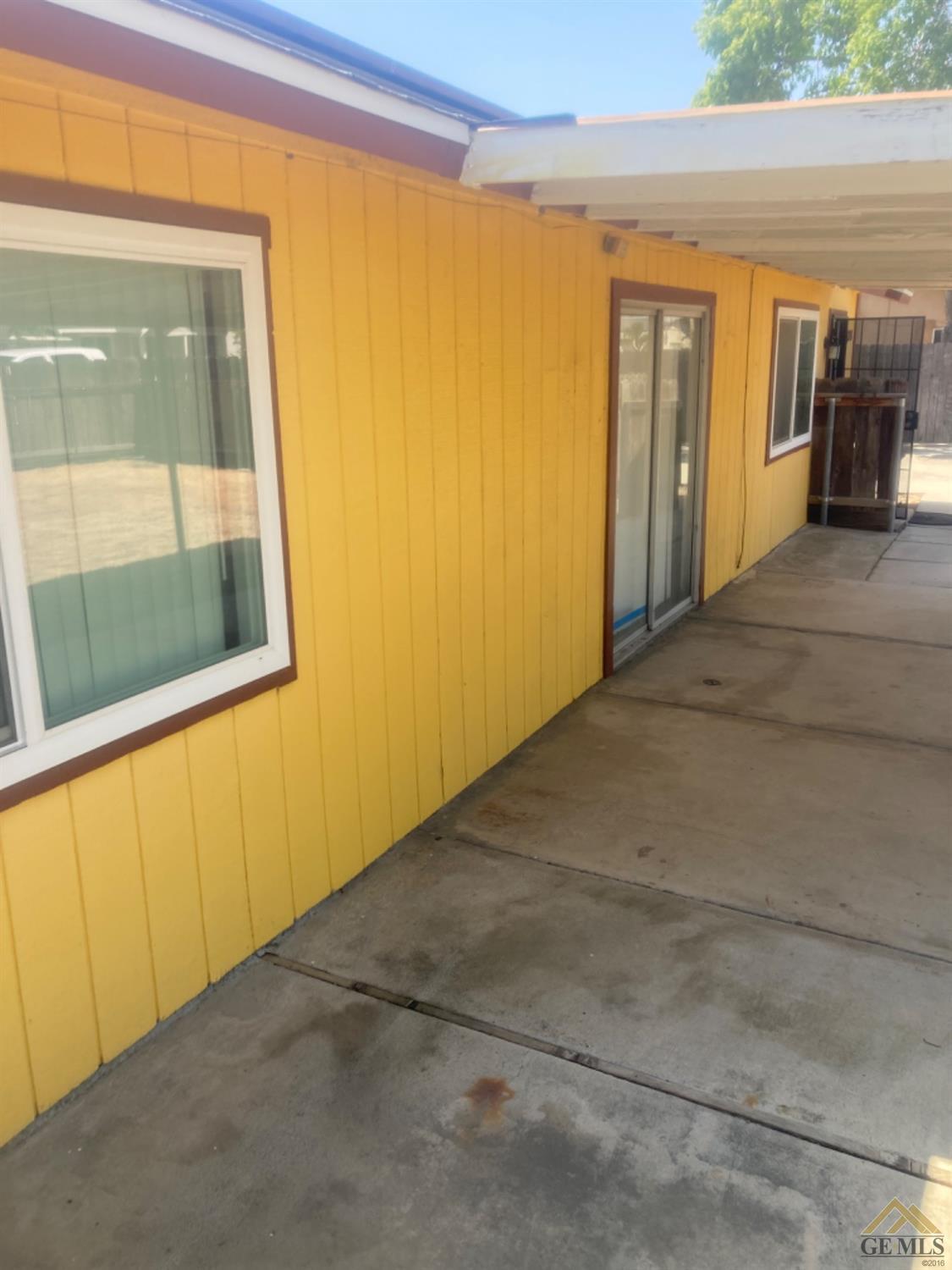 Undisclosed Address Buttonwillow, CA 93206 - Photo 6 of 56 a view of a hallway with wooden floor and a door