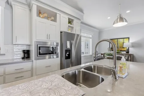 a kitchen with a sink microwave and cabinets