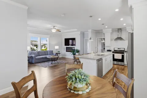 a living room with kitchen island furniture and a kitchen view