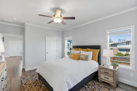 a bedroom with a bed and a chandelier