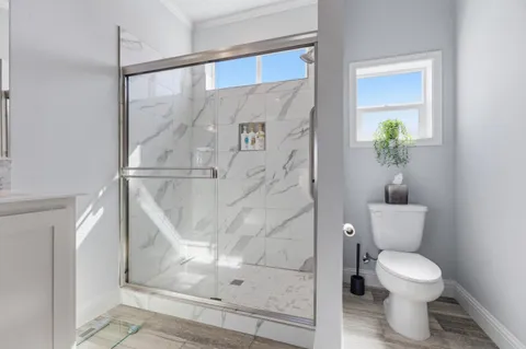 a bathroom with a toilet and a shower