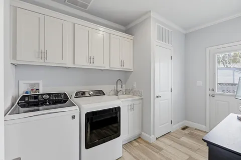 a view of a storage and utility room with washer and dryer