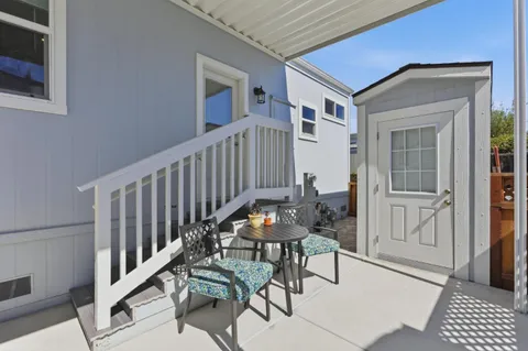 a view of a balcony with furniture