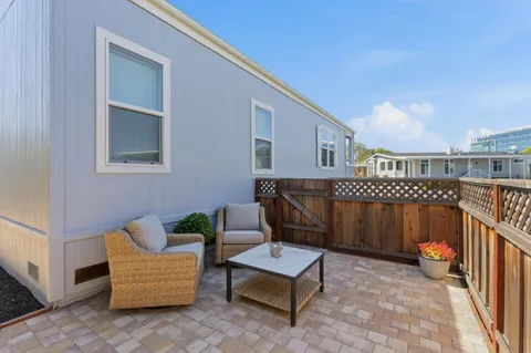 a balcony with furniture and wooden floor
